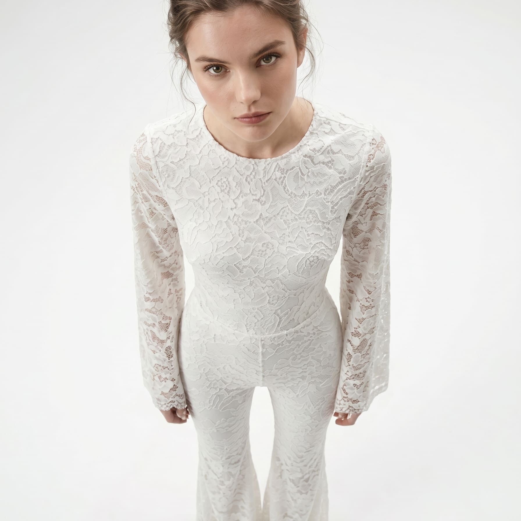 Front view of a white lace catsuit, showing the long sleeves and fitted silhouette.