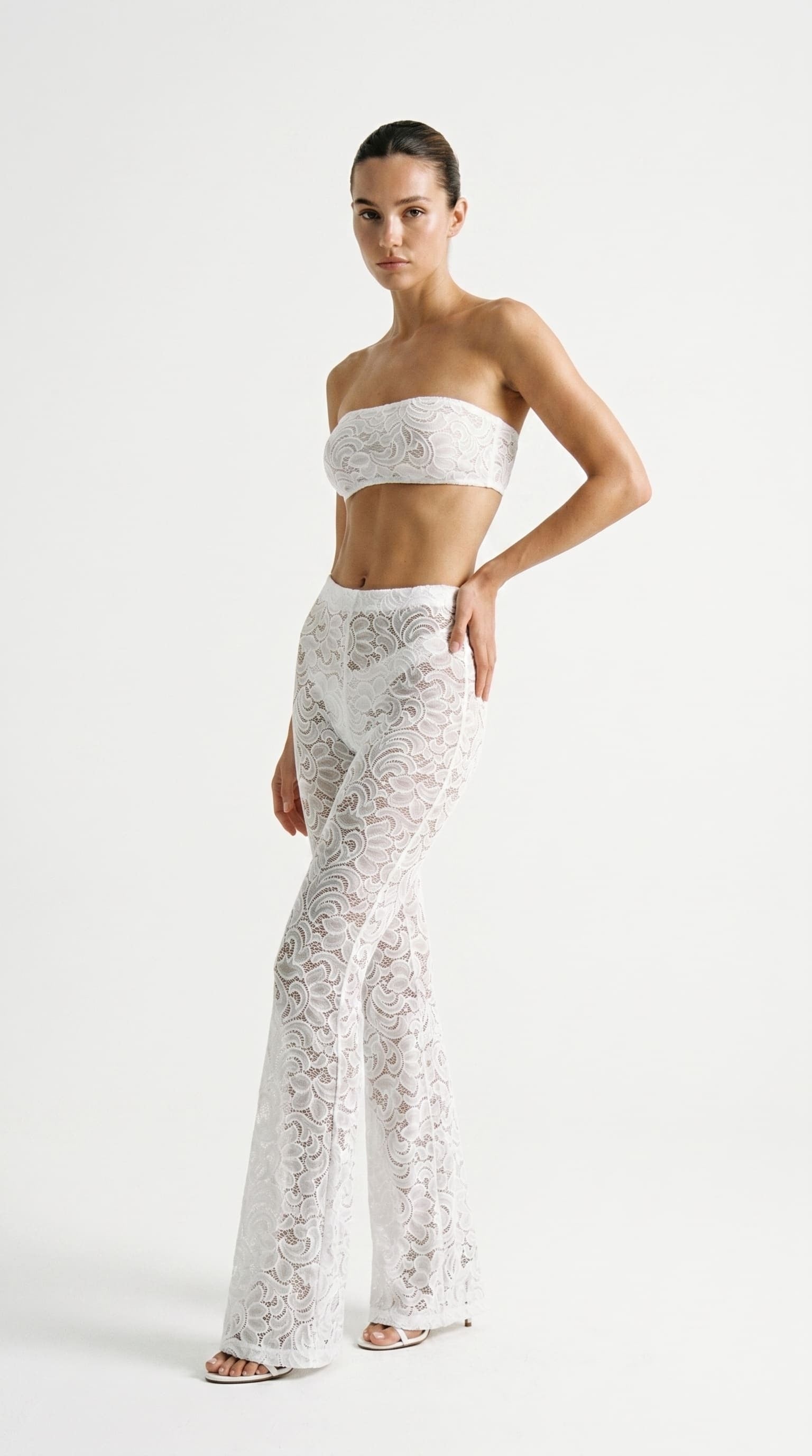 Bespoke white Goddess Aura lace suit with flared pants and bandeau top.