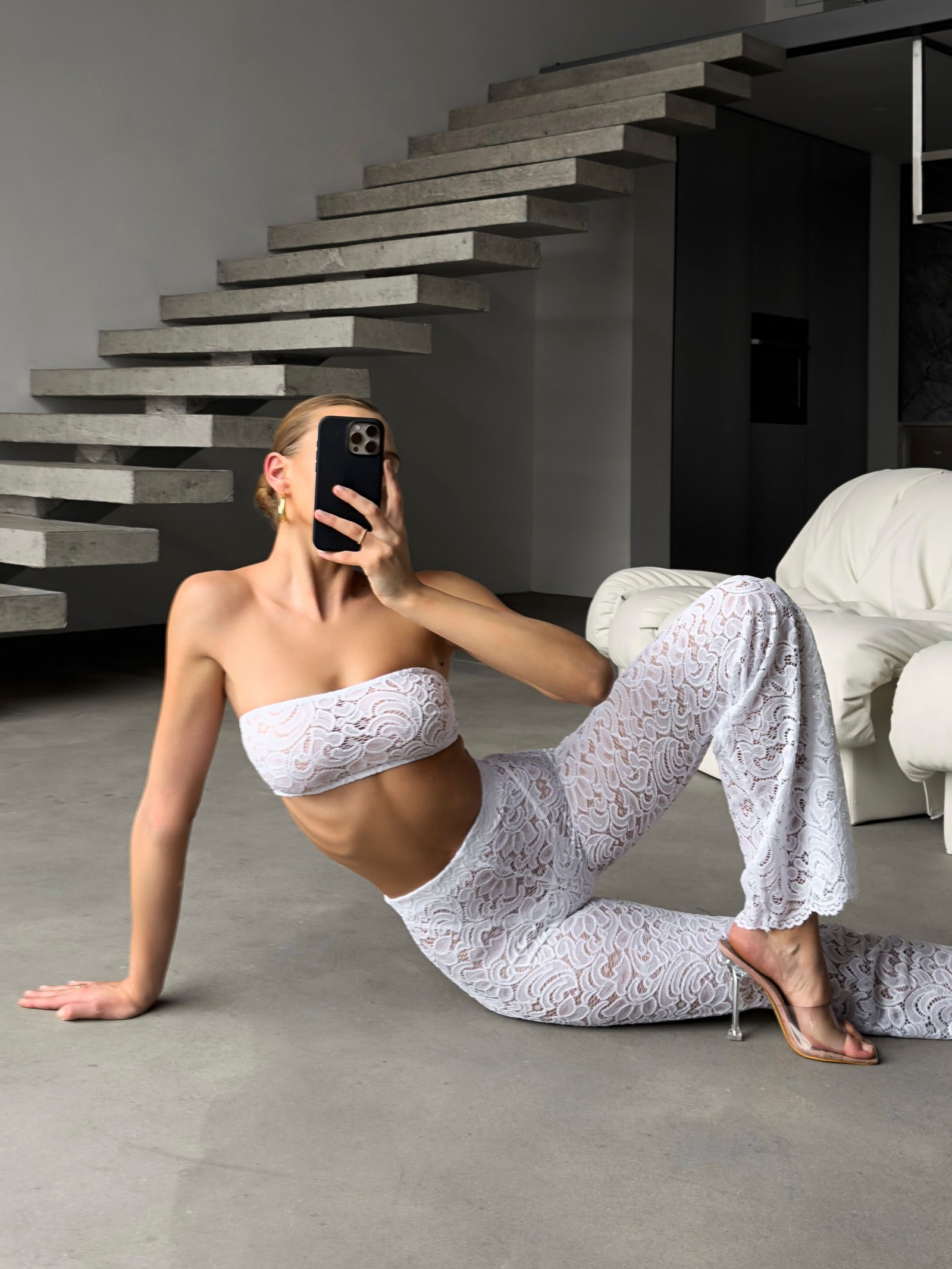 Cinematic back view of the architectural white lace Goddess Aura suit.