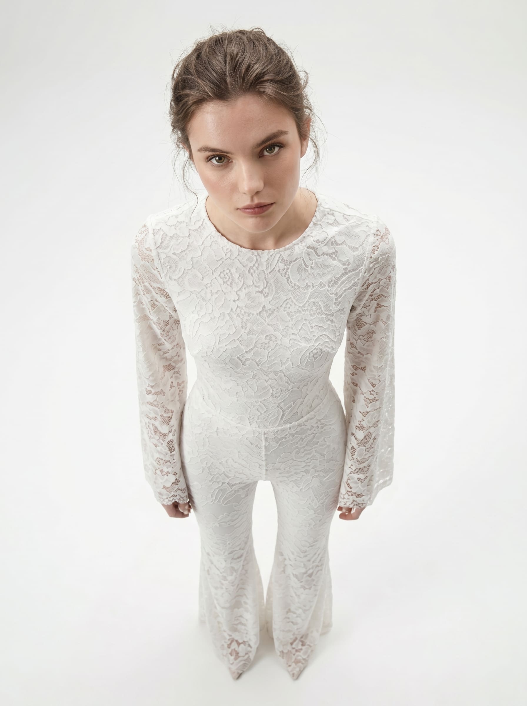 Front view of a white lace catsuit, showing the long sleeves and fitted silhouette.