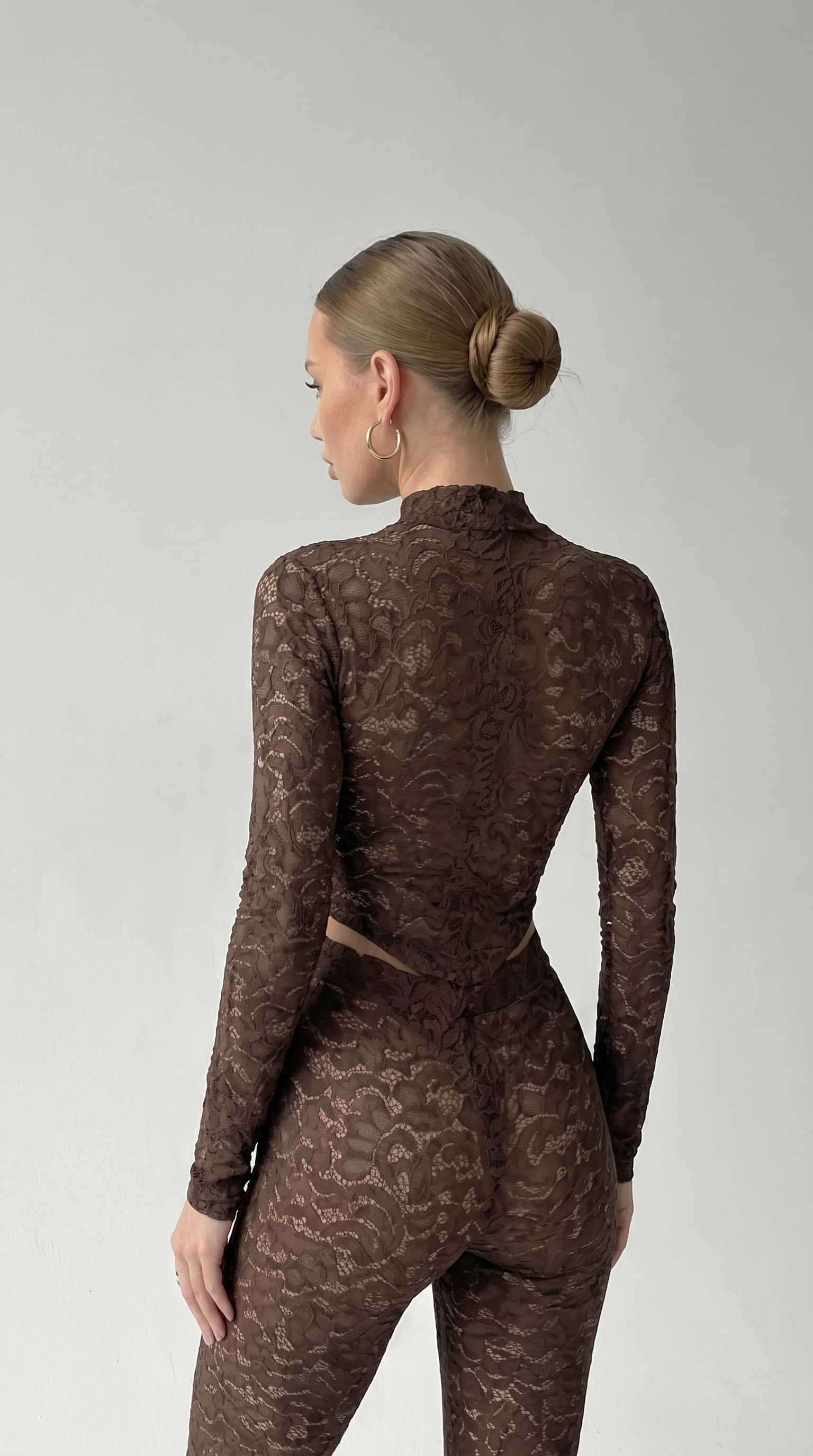 Back view of the Iness de Nuit brown lace catsuit, showing the fitted silhouette.