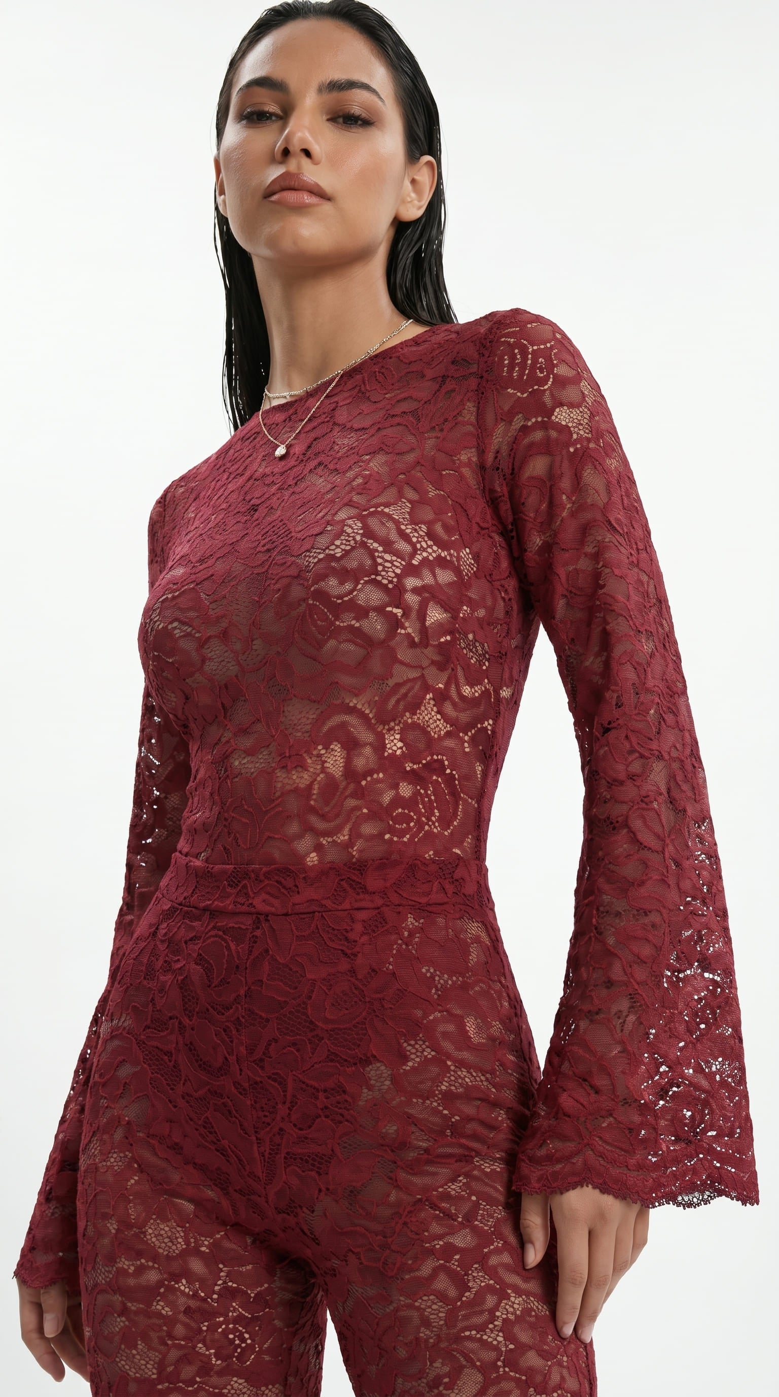 Detailed view of artisanal stretch lace embroidery on the red suit.