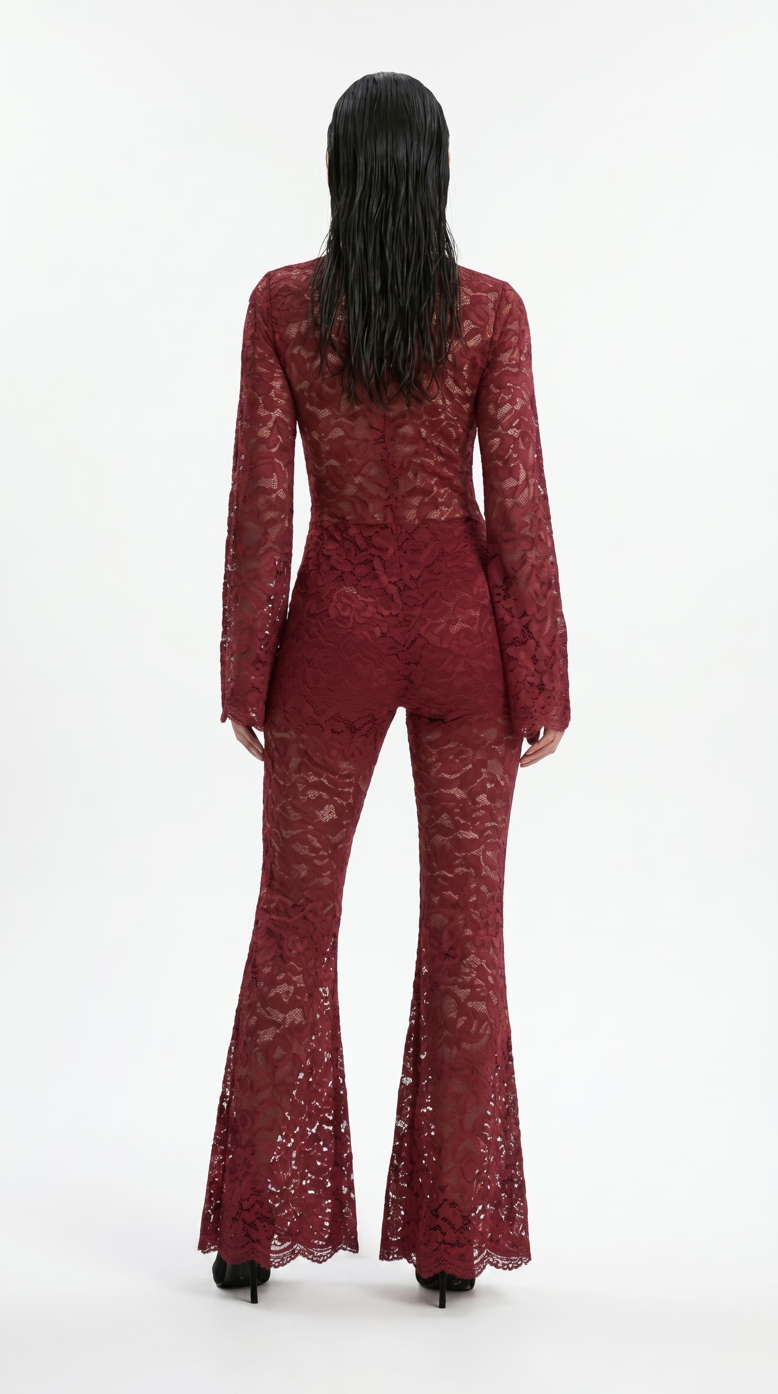 Precision-tailored red lace jumpsuit designed for a second-skin fit.