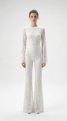 Precision-tailored white lace jumpsuit designed for a second-skin fit.