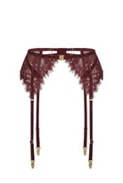 Flat-lay of the Ariana burgundy garter belt with floral lace panels and gold buckle clasp.