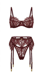 Flat-lay of the complete Ariana burgundy lingerie set — floral lace bra, garter belt, and matching panties.