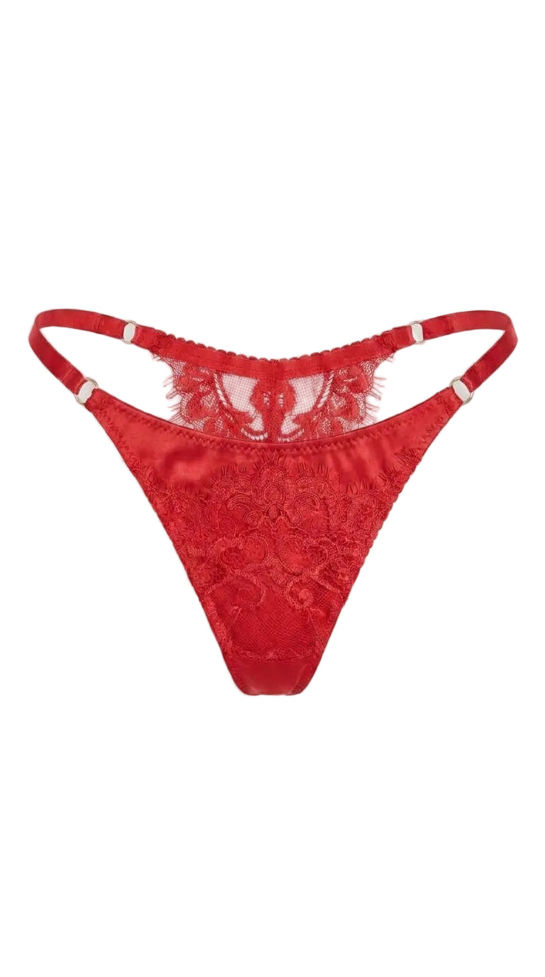 Product shot of the Bella red lace thong on a white background, highlighting the adjustable side straps and lace detailing.
