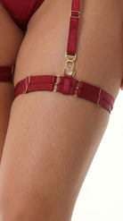 Handcrafted red leg garter with signature gold-toned ring detail.