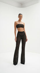 Cinematic back view of the architectural black lace Goddess Aura suit.