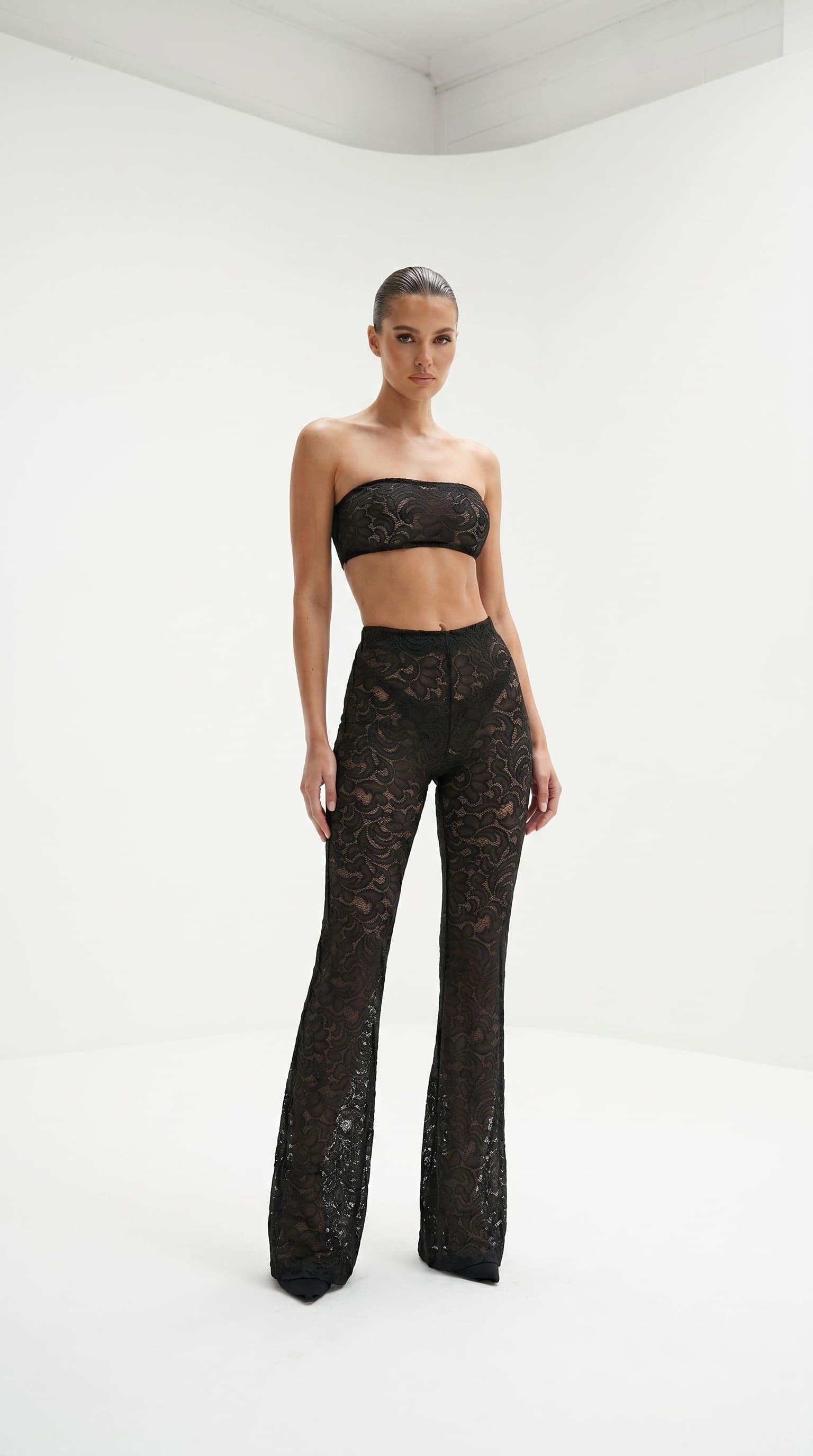 Cinematic back view of the architectural black lace Goddess Aura suit.