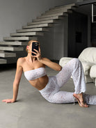 Cinematic back view of the architectural white lace Goddess Aura suit.