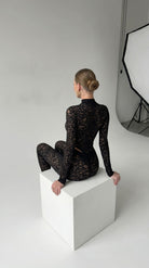 Bespoke black floral lace suit with a high-neck design from the Iness de Nuit collection.