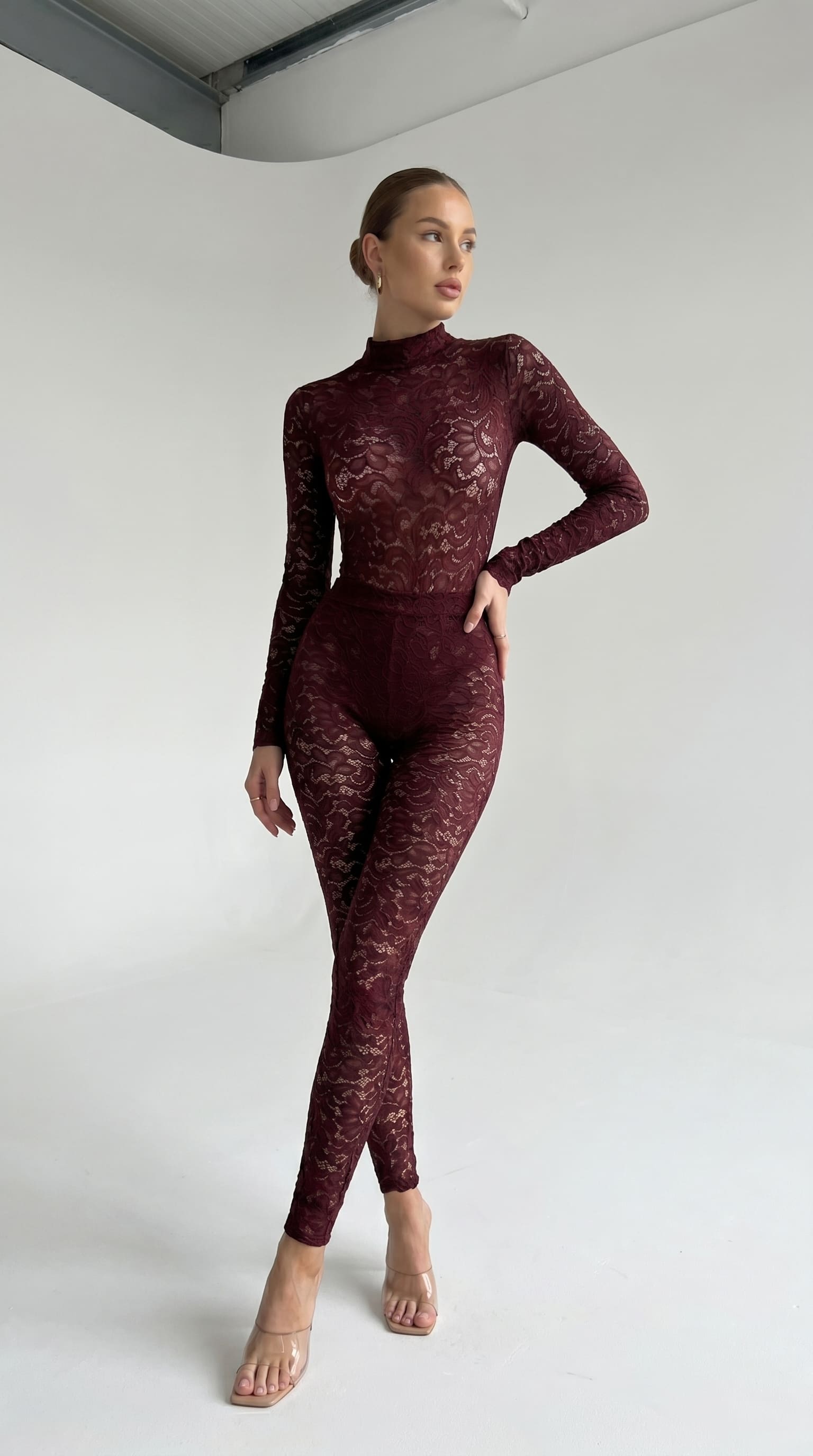 Provocative bordeaux lace jumpsuit from the Iness de Nuit series with a powerful second-skin fit.