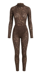 Cinematic back view of the brown Iness de Nuit lace suit featuring custom architectural tailoring.