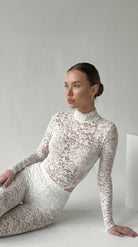 Handcrafted white lace jumpsuit from the Iness de Nuit collection tailored to unique metrics.