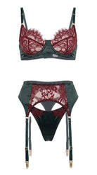 Product flat-lay of the Kleo emerald and burgundy lace bra and garter belt set on a white background, showing the floral lace pattern and satin trim.