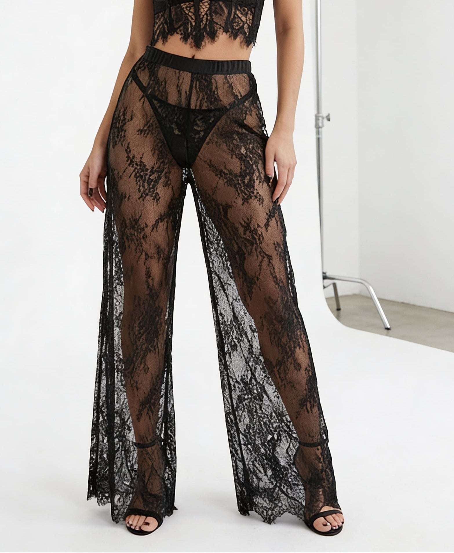 Close-up of the premium handcrafted lace detailing and seams on the bodysuit