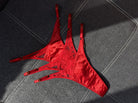 Artisanal red Mono Box set featuring three handcrafted lace panties.