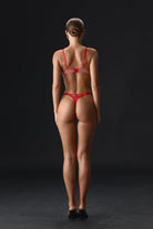 Back view of Odri Red 3-piece lingerie set featuring red Chantilly lace, strappy bra, and garter belt.