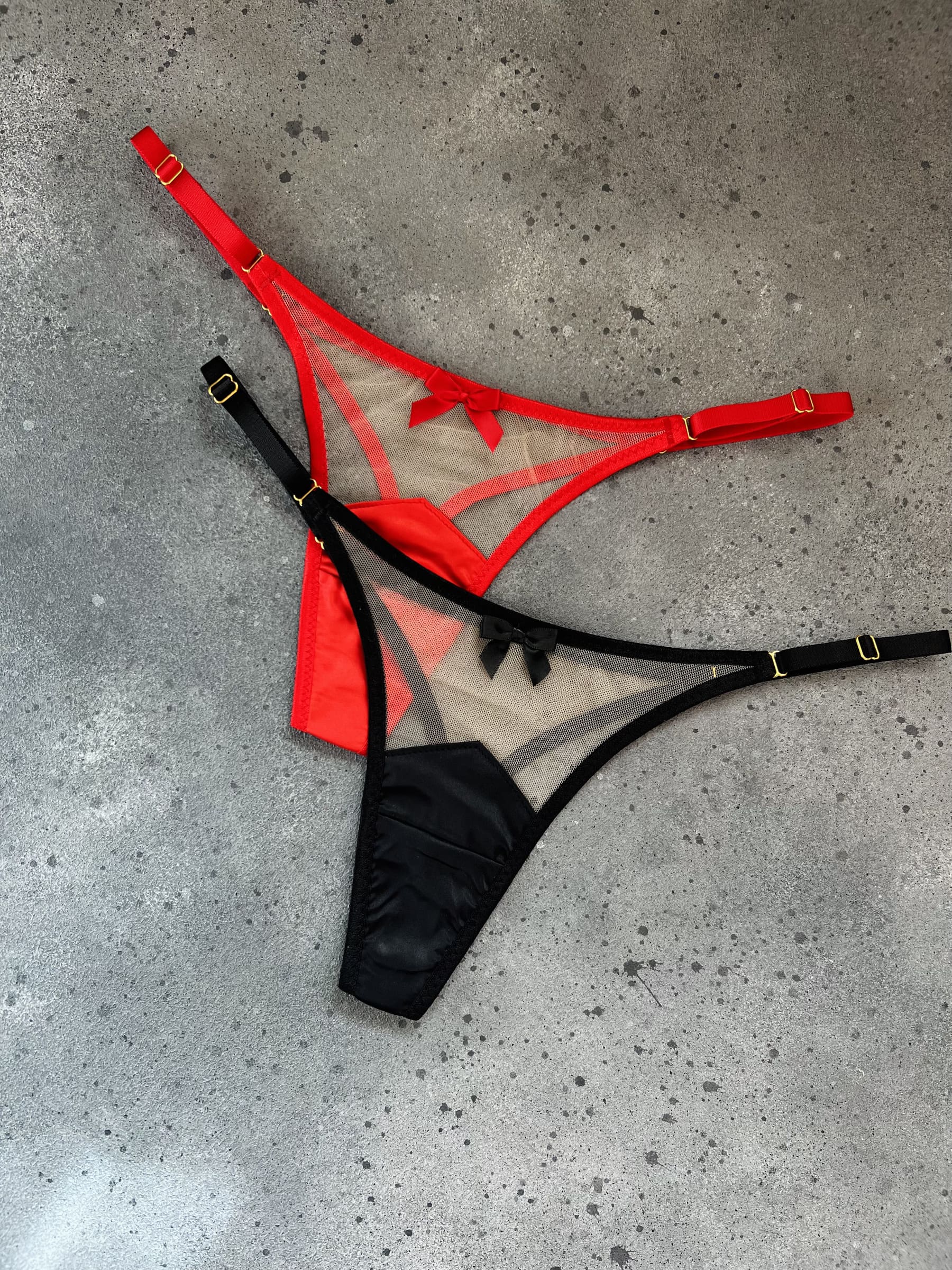 Close-up of the handcrafted Provocation mesh panties showing intricate strappy details and gold adjusters designed for a provocative second-skin silhouette.