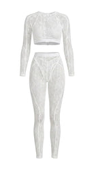 Bespoke white Sensual Edge lace suit with architectural open-back detail.