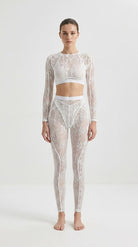 Handcrafted white floral lace jumpsuit designed for a second-skin fit.